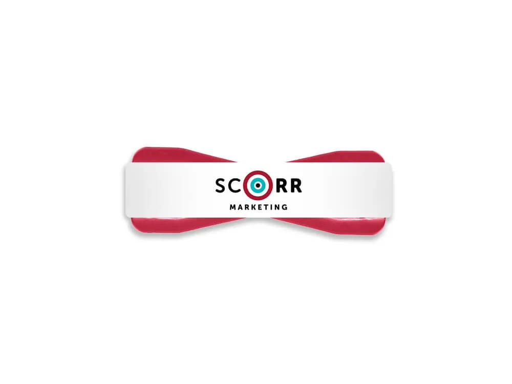 A red and white SCORR-branded phone grip shaped like a bowtie, designed for better phone handling and grip security.