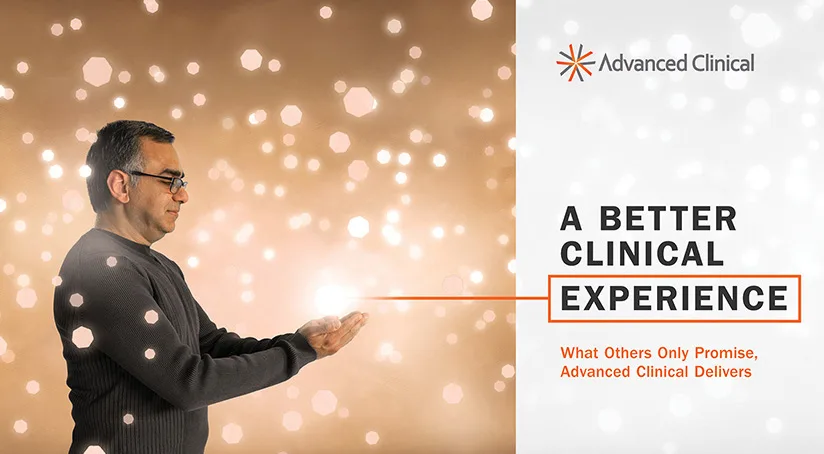 This image showcases an alternate "big idea" image for Advanced Clinical, featuring a man wearing glasses and a gray sweater holding a glowing light in his hands. The background is filled with soft, blurred golden lights that create a warm, glowing atmosphere. The accompanying text emphasizes "A Better Clinical Experience," with the tagline "What Others Only Promise, Advanced Clinical Delivers."