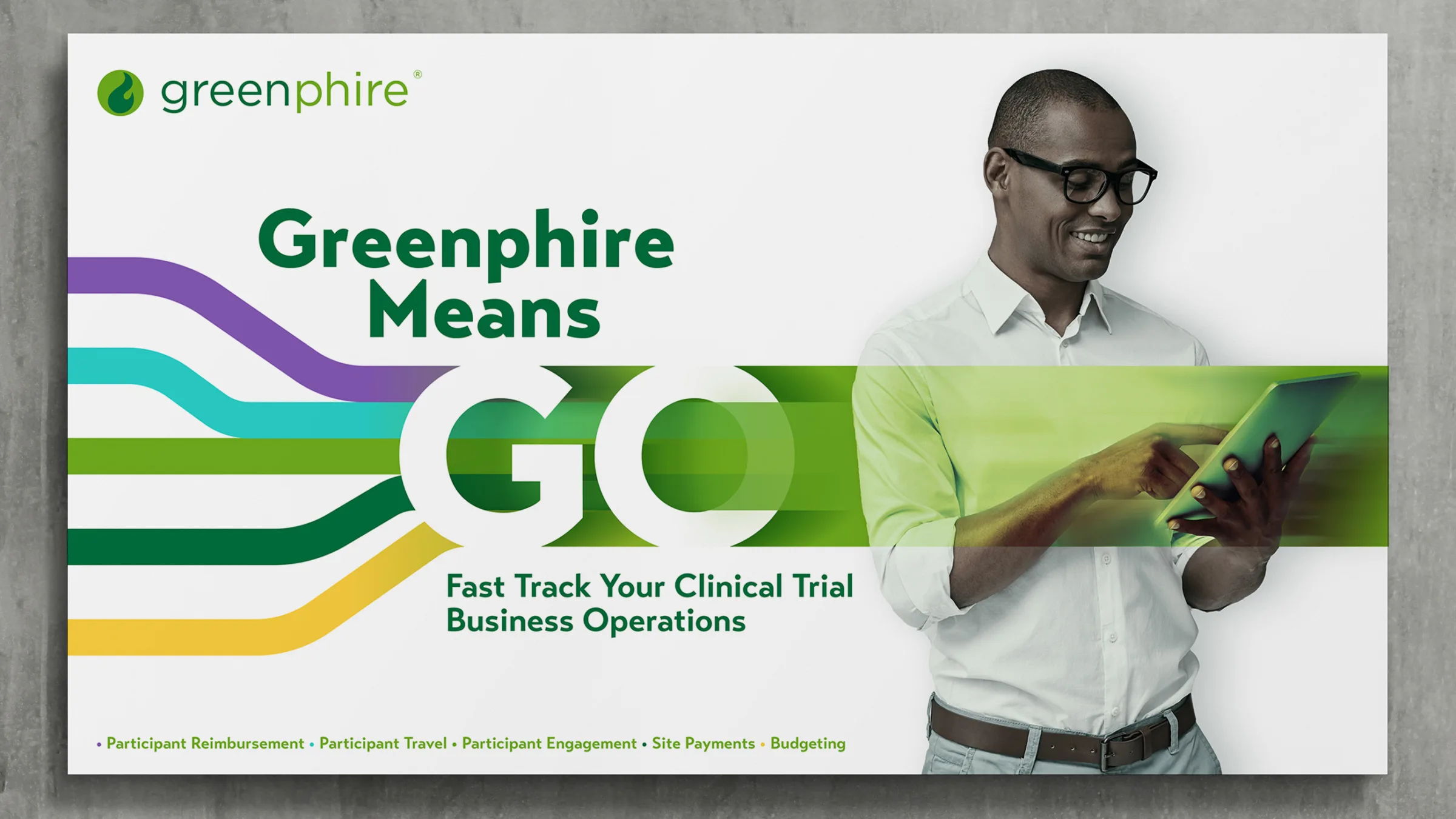 The big idea for Greenphire featuring the bold phrase "Greenphire Means GO" with dynamic, multicolored lines representing speed and streamlined operations, alongside a smiling man using a tablet; tagline emphasizes "Fast Track Your Clinical Trial Business Operations."