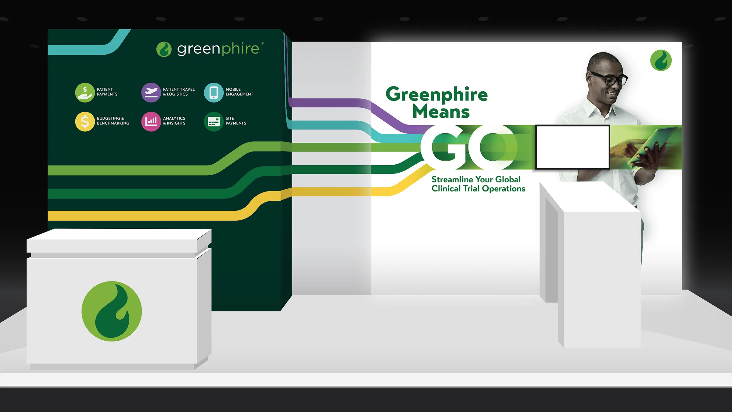 A 10x20 trade show booth for Greenphire featuring the bold message “Greenphire Means GO” across a wide backlit wall, with colorful motion lines flowing through the display. The left panel displays service icons including patient payments and mobile engagement on a dark green background. Two branded counters stand at the front, creating an inviting, modern layout for clinical trial operations promotion.