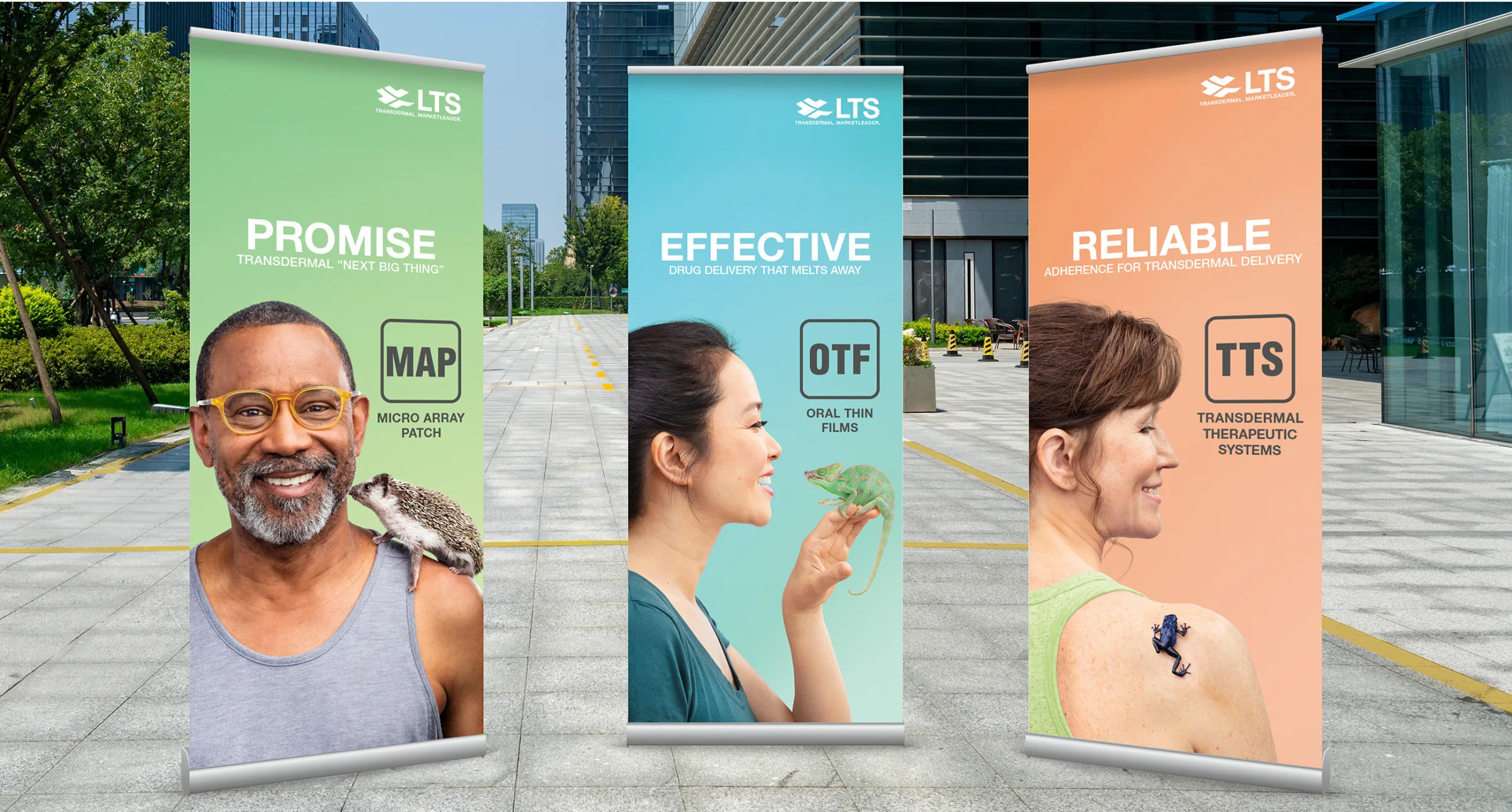The image shows three banner stands for LTS, each highlighting a different aspect of their transdermal drug delivery systems. The first banner is titled "Promise" and features a man with a hedgehog on his shoulder, promoting the Micro Array Patch (MAP). Beneath the title is the text “transdermal ‘next big thing’”, and the background is a light green gradient. The second banner is titled "Effective" and features a woman holding a chameleon, promoting Oral Thin Films (OTF). Beneath the title is the text “drug delivery that melts away”, and the background is a light blue gradient. The third banner is titled "Reliable" and features a woman with a frog on her shoulder, promoting Transdermal Therapeutic Systems (TTS). Beneath the title is the text “adherence for transdermal delivery”, and the background is a peach-colored gradient.