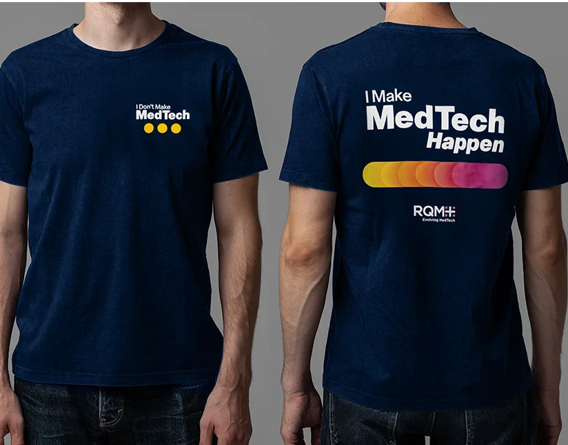 This image shows T-shirts created for the employee brand launch event. The front of the shirt features the text "I Don’t Make MedTech" with three yellow dots, while the back showcases "I Make MedTech Happen" with a colorful progression of dots in yellow, orange, and pink. The RQM+ logo appears at the bottom of the back. The design reflects the transition in the company's branding message, aligning with the vibrant and impactful visual identity of RQM+ and its evolution in the MedTech space.