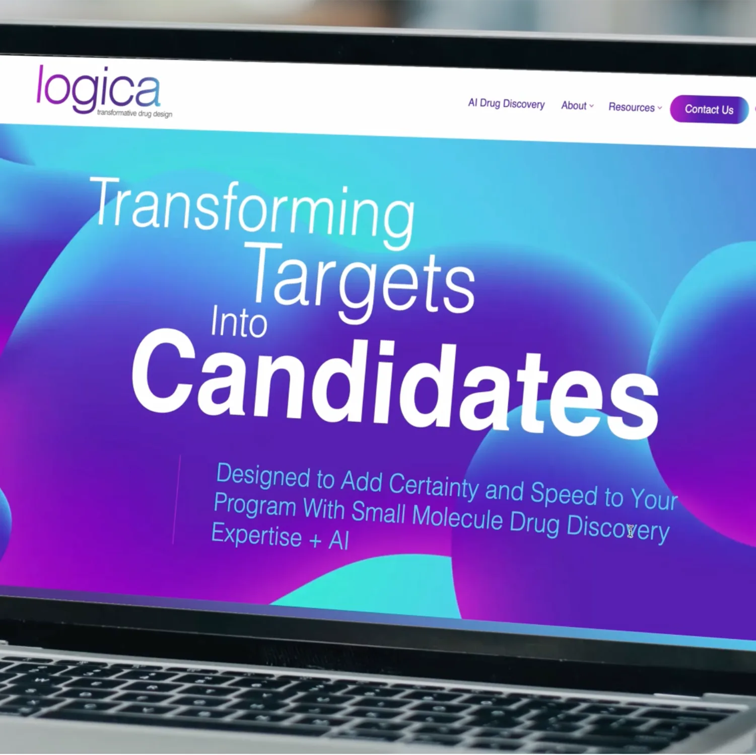 Laptop screen displaying the Logica homepage with colorful gradients and bold text about transforming targets into candidates, representing life science marketing for AI-driven drug discovery.