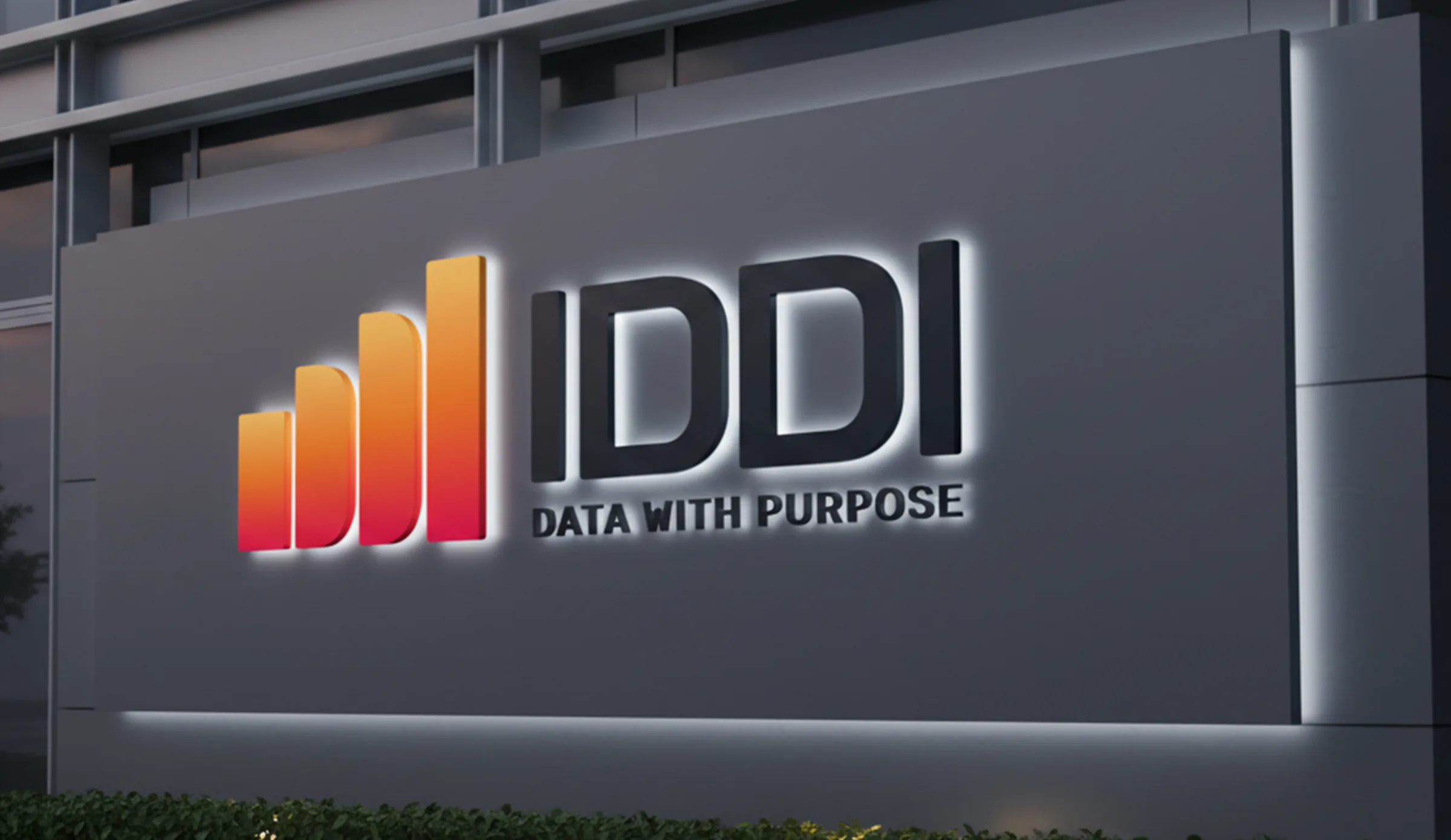Exterior building signage with illuminated IDDI logo and tagline data with purpose